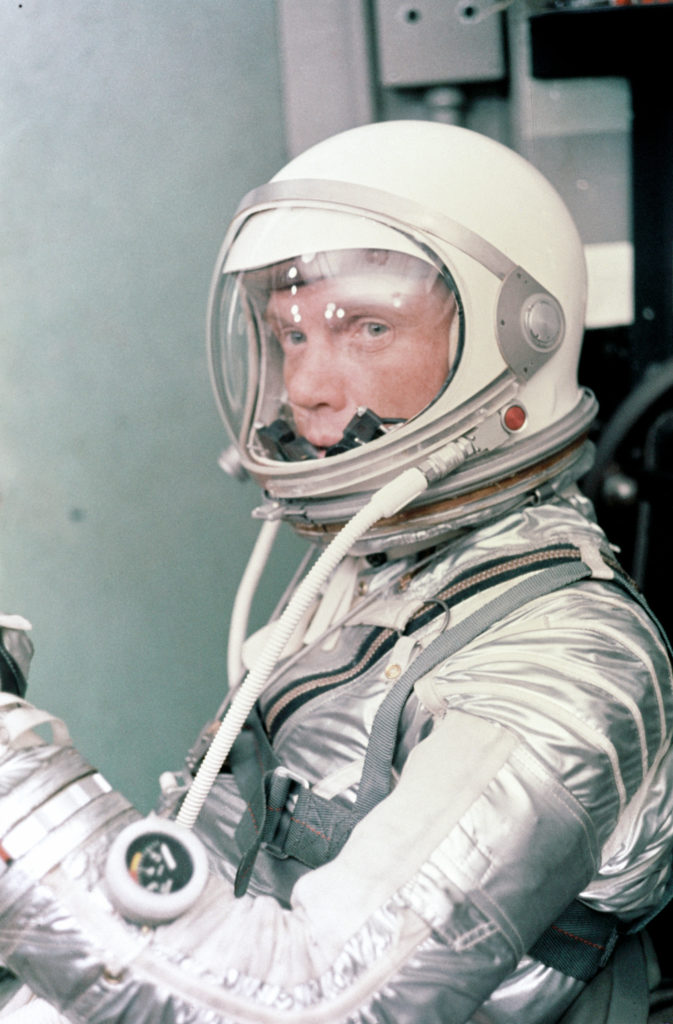 Astronaut John H. Glenn Jr. dons his silver Mercury pressure suit in preparation for launch. On February 20, 1962 Glenn lifted off into space aboard his Mercury Atlas (MA-6) rocket and became the first American to orbit the Earth. After orbiting the Earth 3 times, Friendship 7 landed in the Atlantic Ocean 4 hours, 55 minutes and 23 seconds later, just East of Grand Turk Island in the Bahamas. Glenn and his capsule were recovered by the Navy Destroyer Noa, 21 minutes after splashdown.
