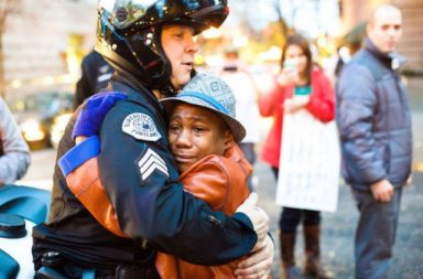 Dallas police consoling people